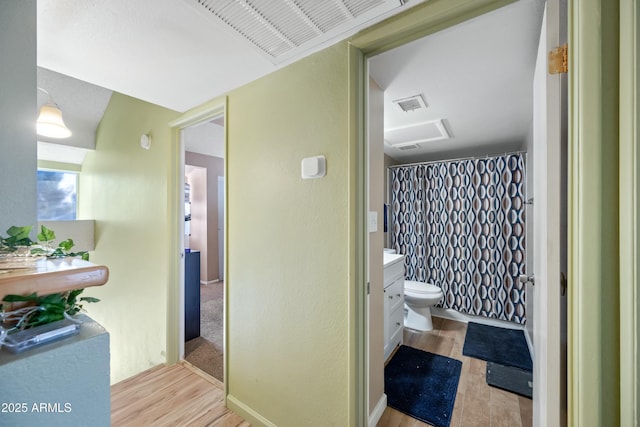 bathroom featuring visible vents, vanity, toilet, and wood finished floors