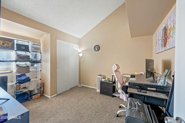 carpeted office space featuring vaulted ceiling, a textured ceiling, and baseboards