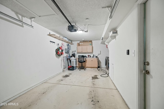 garage featuring washer / clothes dryer and a garage door opener