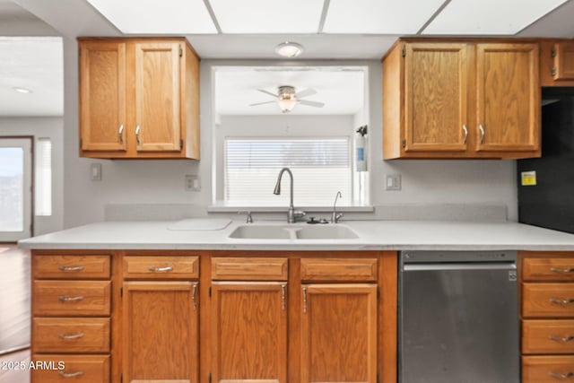 kitchen featuring dishwashing machine, sink, and ceiling fan