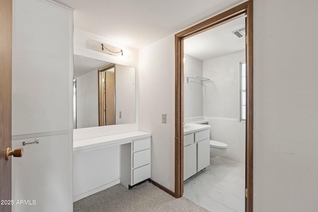 bathroom featuring vanity and toilet