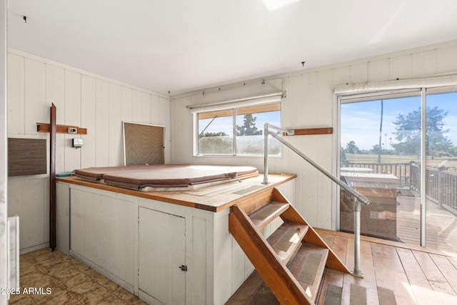 kitchen with white cabinetry, wood-type flooring, and wooden counters