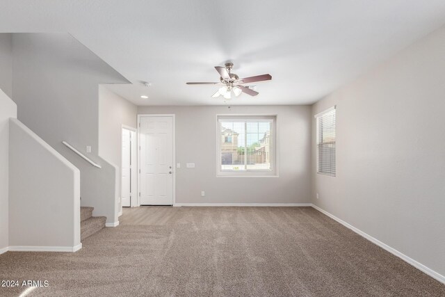 empty room with light colored carpet and ceiling fan