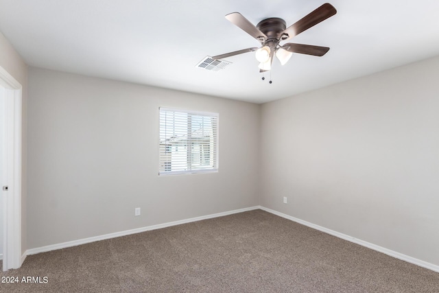 unfurnished room featuring baseboards, visible vents, carpet, and a ceiling fan
