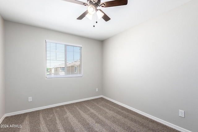 spare room with a ceiling fan, carpet, and baseboards