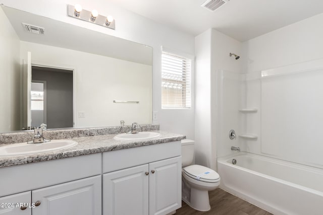 full bathroom featuring vanity, toilet,  shower combination, and hardwood / wood-style flooring