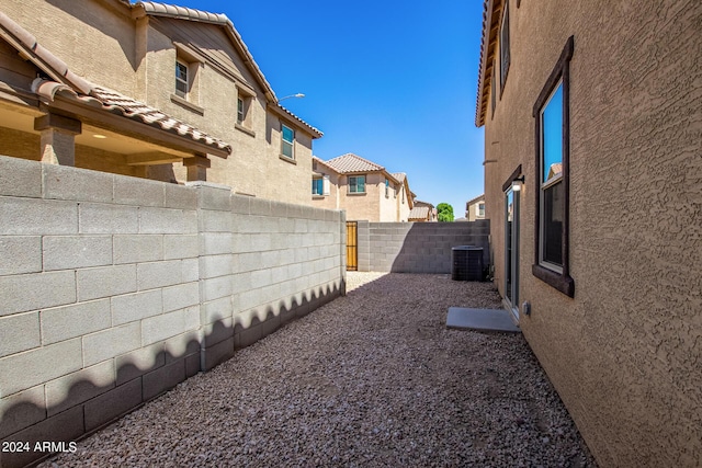 view of yard with a fenced backyard, a residential view, and central AC