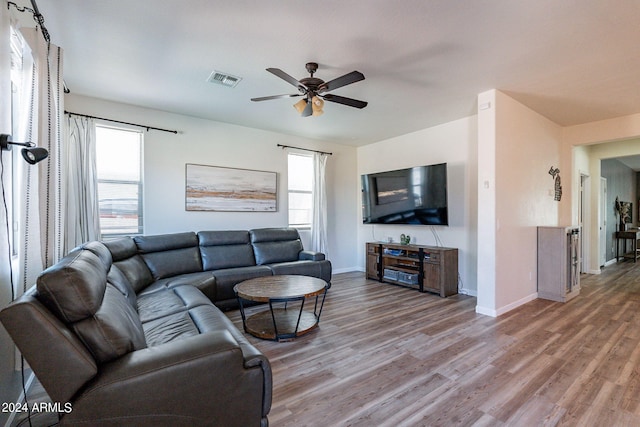 living room featuring hardwood / wood-style floors and ceiling fan