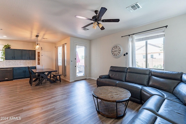 living room featuring dark wood-type flooring and ceiling fan