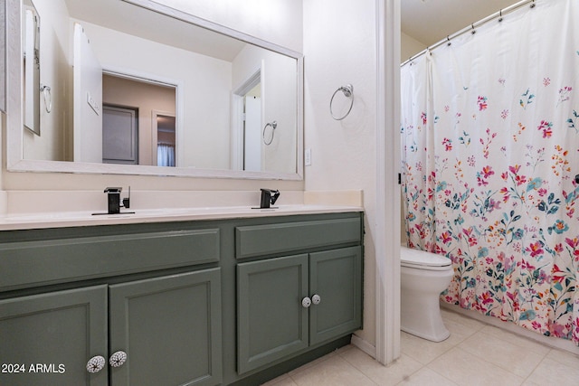 bathroom featuring tile patterned floors, toilet, and vanity