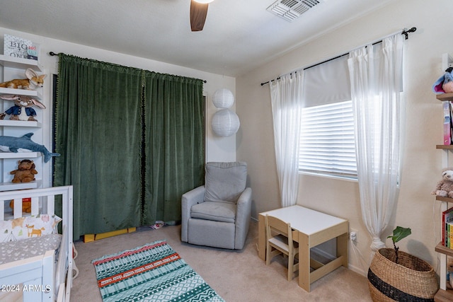 bedroom featuring light colored carpet and ceiling fan