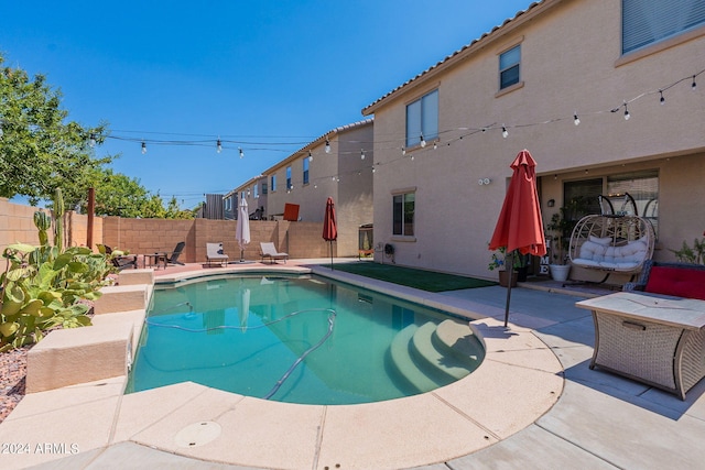 view of swimming pool featuring a patio