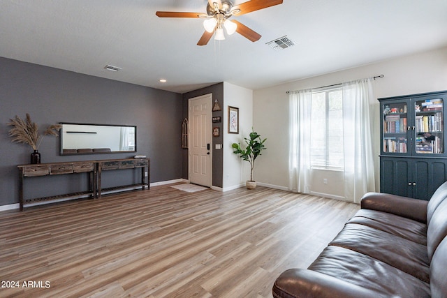 living room featuring ceiling fan and light wood-type flooring