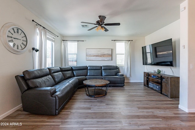 living room with hardwood / wood-style floors and ceiling fan