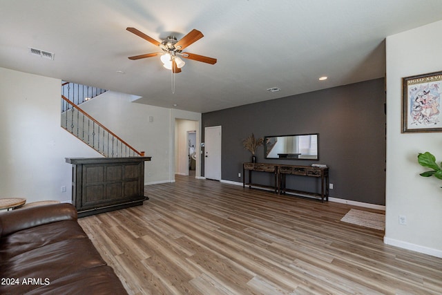 living room with hardwood / wood-style flooring and ceiling fan