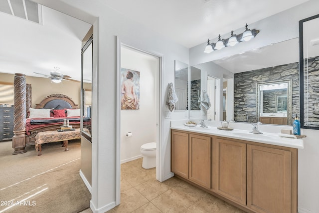 bathroom with tile patterned flooring, ceiling fan, toilet, and vanity