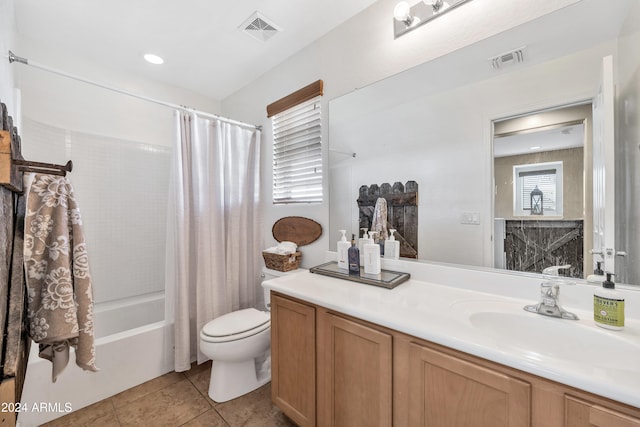 full bathroom with a wealth of natural light, shower / bath combo, tile patterned floors, toilet, and vanity