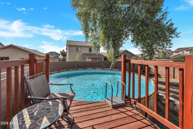 view of swimming pool with a deck