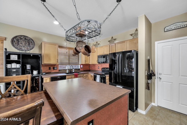 kitchen featuring decorative backsplash, light brown cabinetry, sink, and black appliances