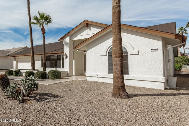 rear view of house featuring a garage