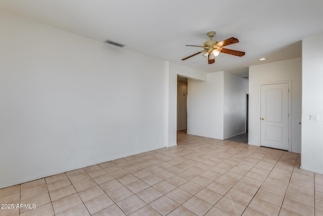 unfurnished room with ceiling fan and visible vents