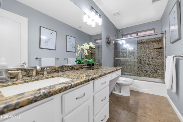 full bathroom featuring combined bath / shower with glass door, vanity, tile patterned flooring, and toilet