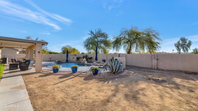 view of yard featuring a fenced in pool and a patio