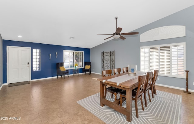 dining space featuring ceiling fan and vaulted ceiling