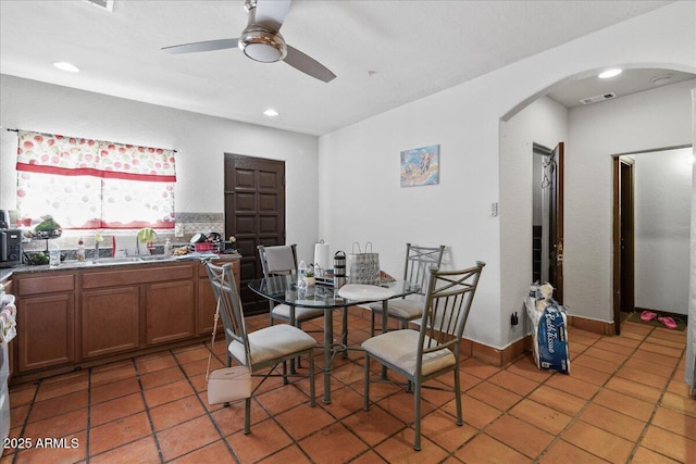 dining area with arched walkways, ceiling fan, light tile patterned floors, and recessed lighting