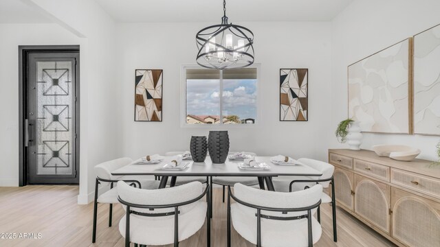 25916 S 198th St, Queen Creek, AZ 85142 - dining room with a notable chandelier and light wood-style floors