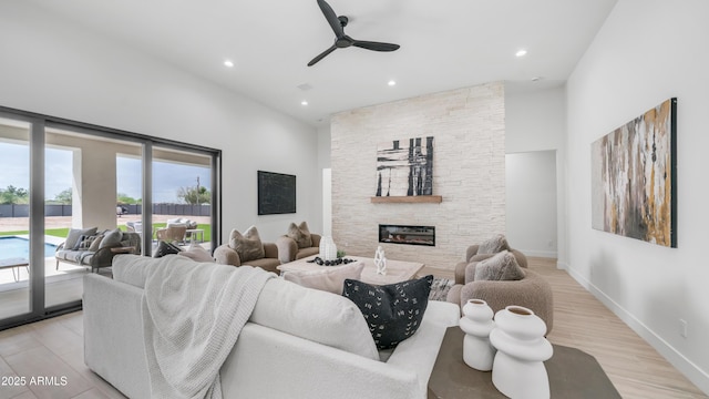 25916 S 198th St, Queen Creek, AZ 85142 - living area featuring a towering ceiling, recessed lighting, a fireplace, light wood finished floors, and a ceiling fan