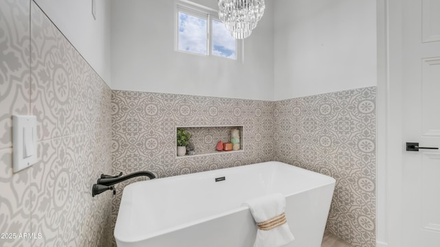 25916 S 198th St, Queen Creek, AZ 85142 - bathroom featuring tile walls, a notable chandelier, a soaking tub, and wainscoting