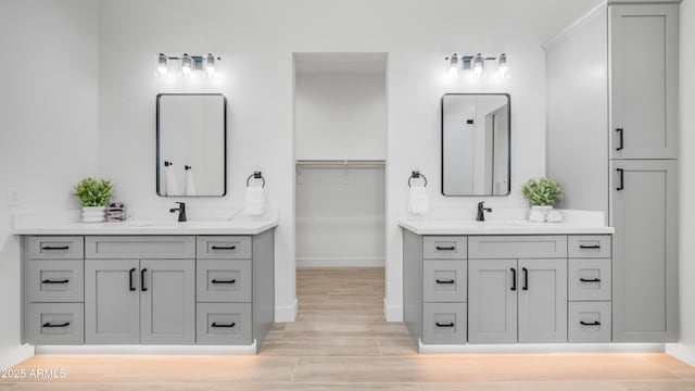 25916 S 198th St, Queen Creek, AZ 85142 - full bath with baseboards, two vanities, a sink, and wood finished floors