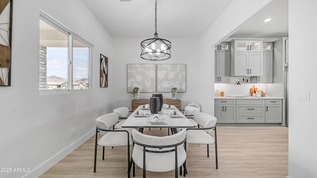 25916 S 198th St, Queen Creek, AZ 85142 - dining space featuring baseboards, recessed lighting, light wood-style flooring, and a chandelier