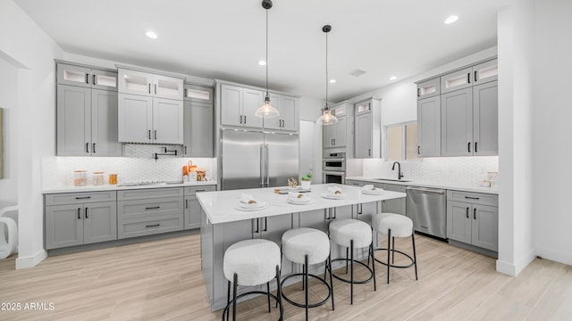25916 S 198th St, Queen Creek, AZ 85142 - kitchen featuring gray cabinetry, stainless steel appliances, tasteful backsplash, and a sink