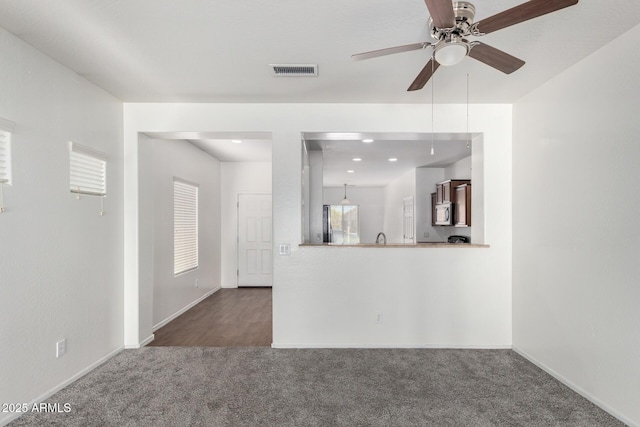26058 W Yukon Dr, Buckeye, AZ 85396 - unfurnished living room featuring carpet, ceiling fan, baseboards, and recessed lighting
