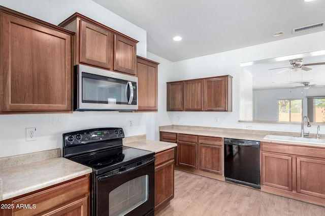 26058 W Yukon Dr, Buckeye, AZ 85396 - kitchen with black appliances, a sink, ceiling fan, light countertops, and recessed lighting