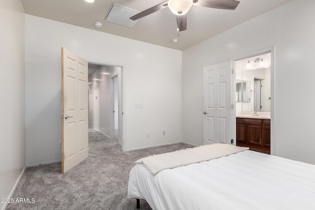 26058 W Yukon Dr, Buckeye, AZ 85396 - carpeted bedroom featuring connected bathroom, a sink, a ceiling fan, and baseboards