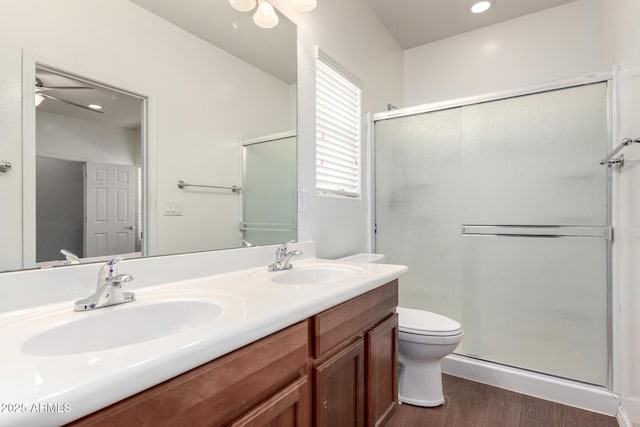 26058 W Yukon Dr, Buckeye, AZ 85396 - full bathroom featuring wood finished floors, a shower stall, double vanity, and ceiling fan