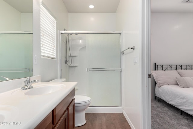 26058 W Yukon Dr, Buckeye, AZ 85396 - bathroom with a shower stall, double vanity, wood finished floors, and toilet