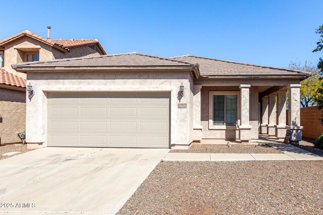 26058 W Yukon Dr, Buckeye, AZ 85396 - view of front facade featuring concrete driveway, a garage, stucco siding, and a porch