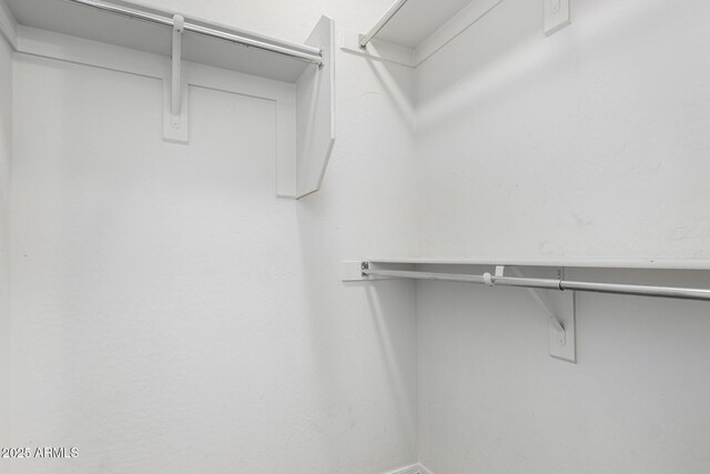 26058 W Yukon Dr, Buckeye, AZ 85396 - unfurnished bedroom with carpet, a closet, baseboards, and a ceiling fan