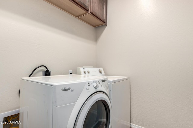 26058 W Yukon Dr, Buckeye, AZ 85396 - laundry room featuring cabinet space, independent washer and dryer, and a textured wall