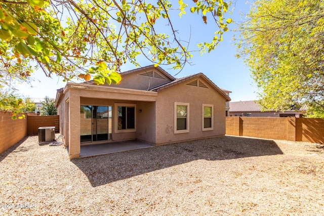 26058 W Yukon Dr, Buckeye, AZ 85396 - rear view of property with central AC unit, a fenced backyard, stucco siding, and a patio area