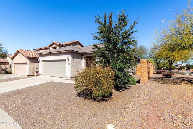 26058 W Yukon Dr, Buckeye, AZ 85396 - view of front of house with stucco siding, a garage, driveway, and a tiled roof