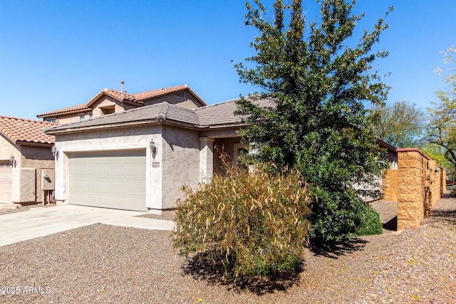 26058 W Yukon Dr, Buckeye, AZ 85396 - view of front of home with an attached garage, stucco siding, concrete driveway, and a tiled roof