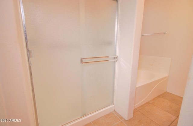 bathroom featuring tile patterned flooring and plus walk in shower