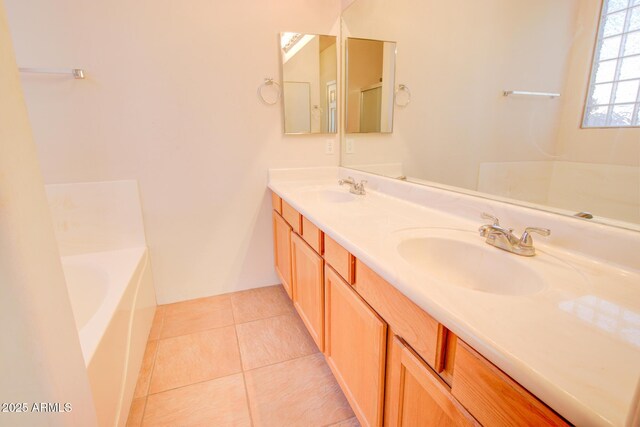 bathroom with vanity, a tub, and tile patterned floors