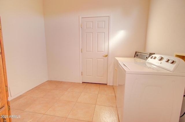 laundry area featuring separate washer and dryer and light tile patterned floors