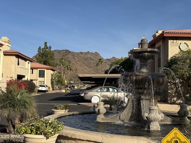 uncovered parking lot featuring a mountain view